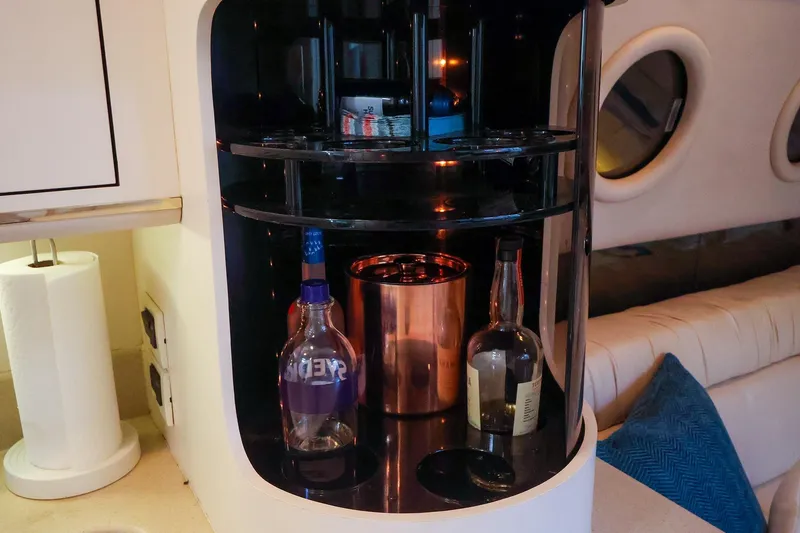Slide: The Image of Interior of 1998 Sea Ray 500 Sundancer with a built-in bar and bottles. - 40
