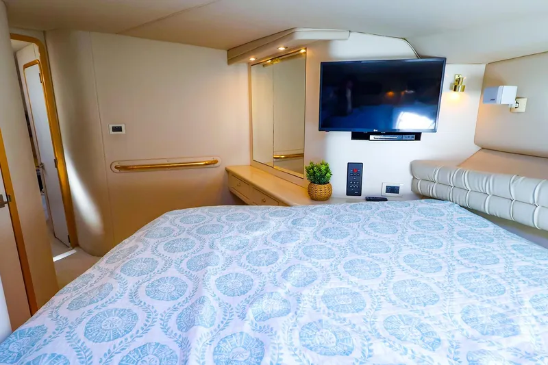 Slide: The Image of Luxurious 1998 Sea Ray 500 Sundancer cabin with TV, bed, and elegant decor. - 43