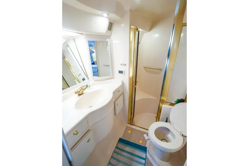 Slide: The Image of Luxurious bathroom in 1998 Sea Ray 500 Sundancer yacht, featuring shower and vanity. - 45