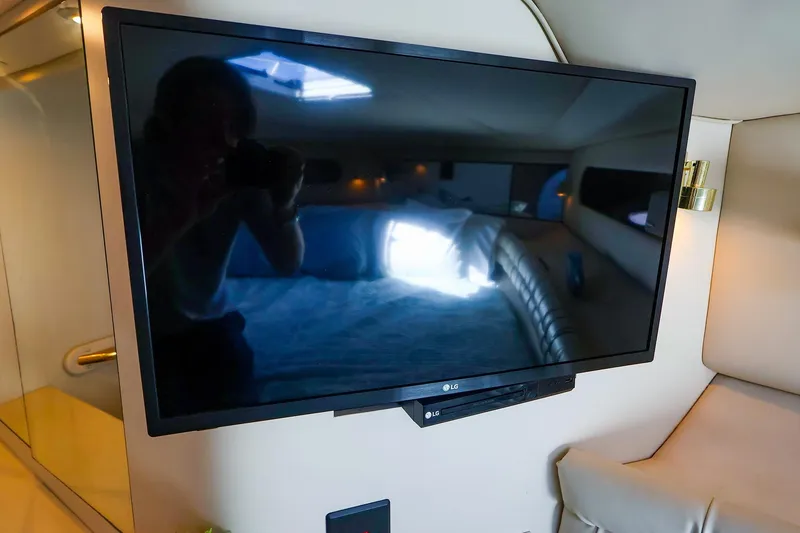Slide: The Image of LG TV inside 1998 Sea Ray 500 Sundancer yacht cabin, reflecting interior. - 46