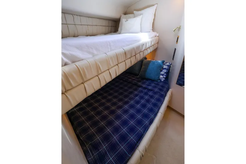 Slide: The Image of Bunk beds in 1998 Sea Ray 500 Sundancer yacht cabin, featuring cozy bedding and pillows. - 48