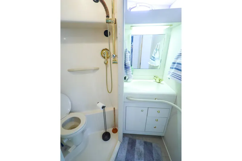 Slide: The Image of Bathroom interior of 1998 Sea Ray 500 Sundancer yacht, featuring shower and vanity. - 49