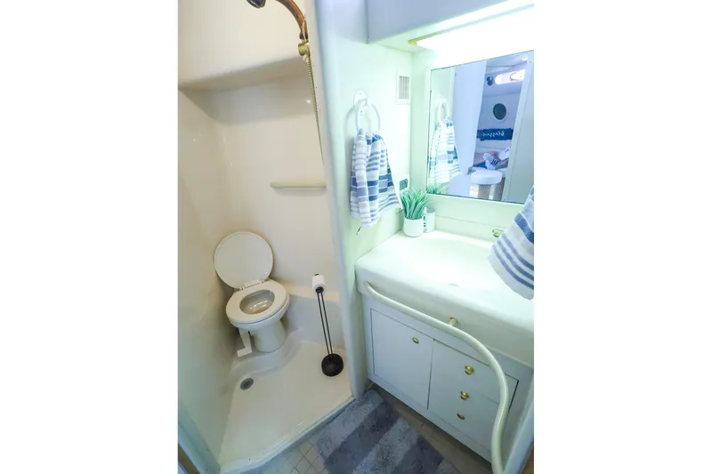 Slide: The Image of Bathroom interior of 1998 Sea Ray 500 Sundancer yacht, featuring shower and vanity. - 50