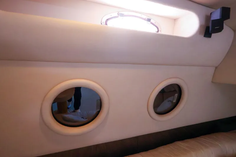 Slide: The Image of Interior view of 1998 Sea Ray 500 Sundancer yacht with portholes. - 54