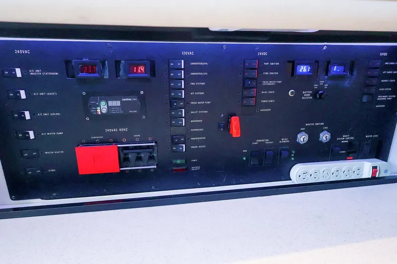 Slide: The Image of Control panel of a 1998 Sea Ray 500 Sundancer yacht, featuring various switches and gauges. - 55