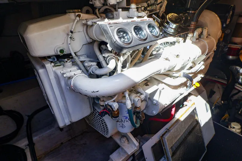 Slide: The Image of Engine compartment of a 1998 Sea Ray 500 Sundancer boat, showcasing mechanical components. - 58