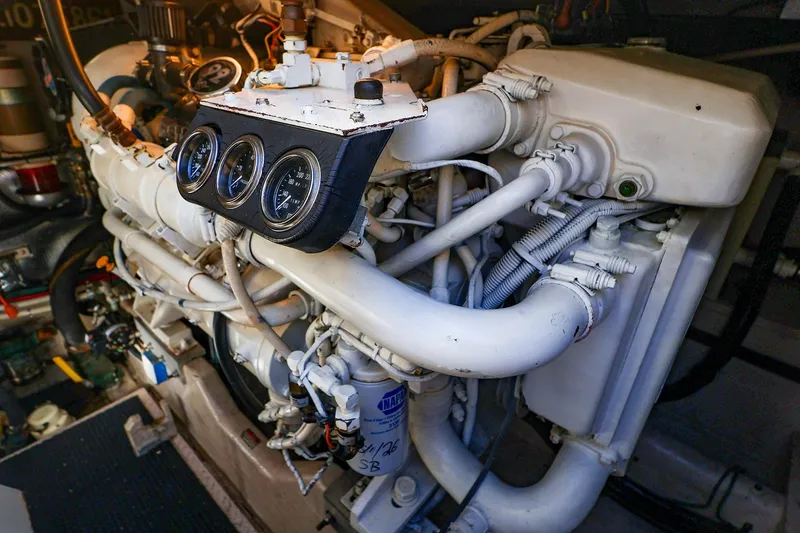 Slide: The Image of Engine compartment of a 1998 Sea Ray 500 Sundancer yacht, showcasing gauges and piping. - 59