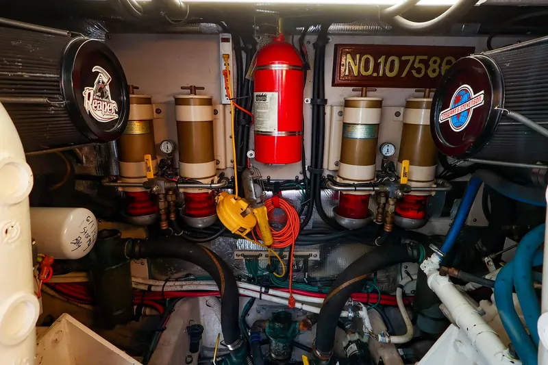 Slide: The Image of Engine room of a 1998 Sea Ray 500 Sundancer with filters and fire extinguisher. - 61