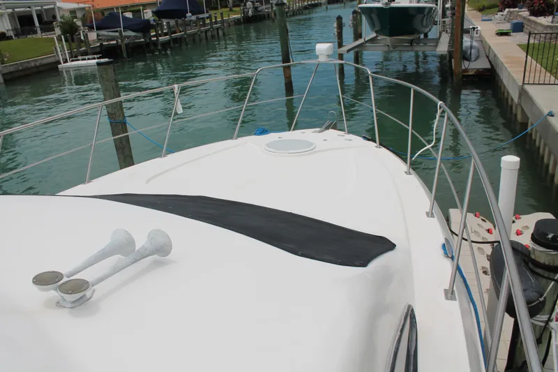 Slide: The Image of 2007 Cruisers Yachts 415 Express Motoryacht docked in a serene marina setting. - 16