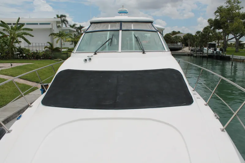 Slide: The Image of 2007 Cruisers Yachts 415 Express Motoryacht docked by lush greenery. - 17
