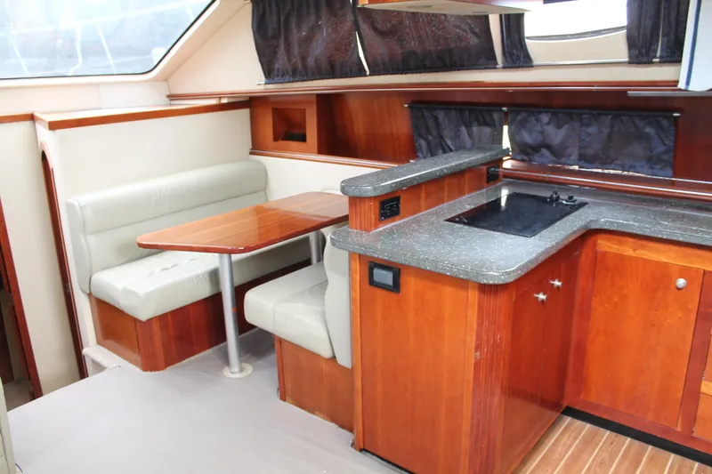 Slide: The Image of Interior of 2007 Cruisers Yachts 415 Express Motoryacht with dining area and kitchenette. - 20