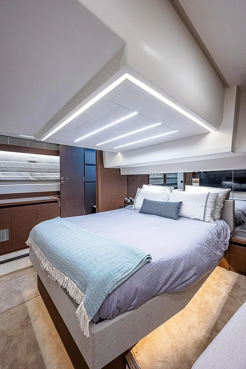 Slide: The Image of Luxurious bedroom interior of 2022 Prestige 520 Fly yacht with modern design and ambient lighting. - 19