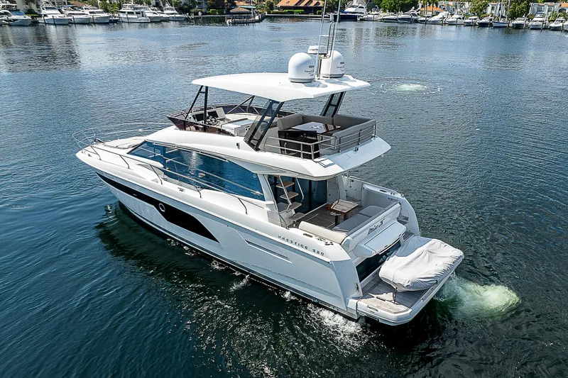 Slide: The Image of 2022 Prestige 520 Fly yacht cruising on a serene waterway, showcasing luxury and elegance. - 3