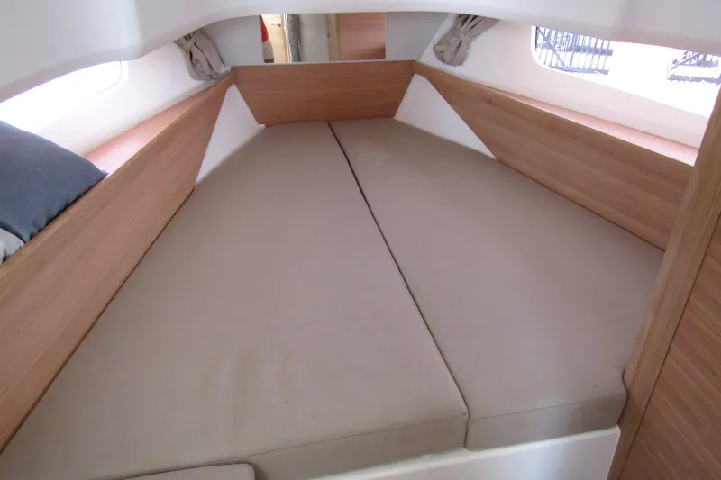 Slide: The Image of Cozy interior cabin of 2025 Nimbus Tender 11 with beige cushions and wooden accents. - 24