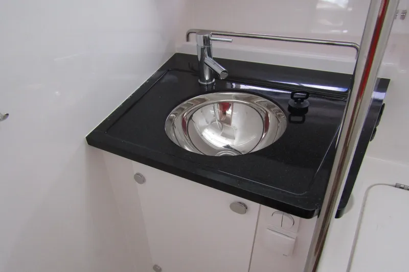Slide: The Image of Modern sink area in 2025 Nimbus Tender 11 boat, featuring sleek design and chrome fixtures. - 29