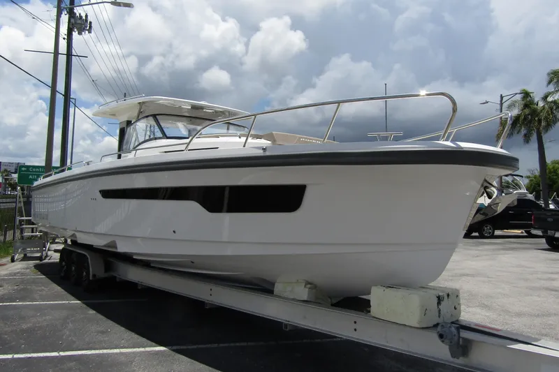 Slide: The Image of 2025 Nimbus Tender 11 boat on trailer under cloudy sky. - 3