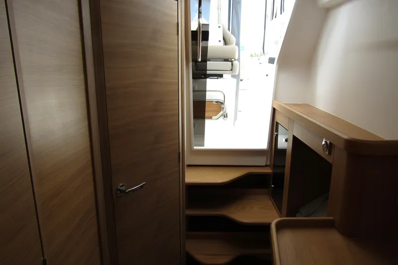 Slide: The Image of Interior view of 2025 Nimbus Tender 11 yacht with wooden cabinetry and steps. - 30
