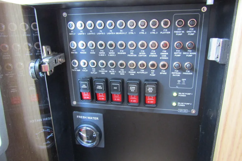 Slide: The Image of Control panel of a 2025 Nimbus Tender 11 boat with switches and indicators. - 33
