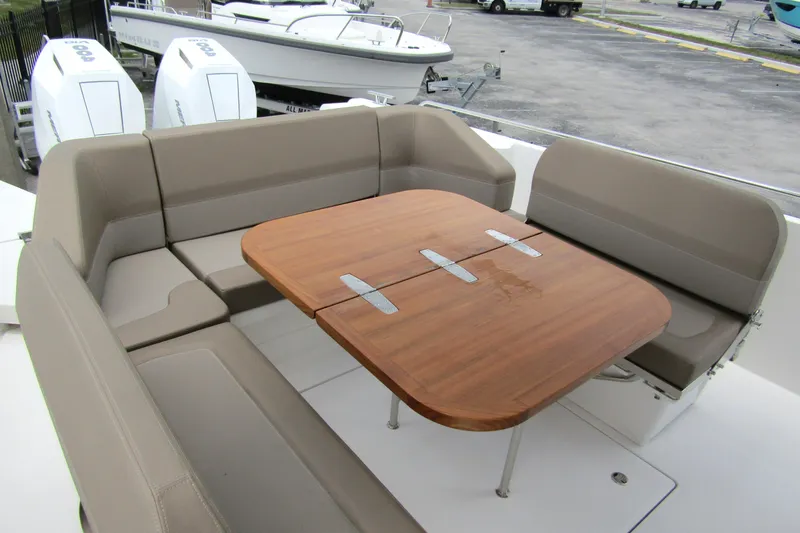 Slide: The Image of Luxurious seating area on 2025 Nimbus Tender 11 boat with wooden table. - 35
