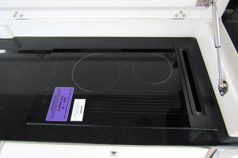 Slide: The Image of Built-in stovetop on Nimbus Tender 11 yacht, 2025 model, with sleek black finish. - 38