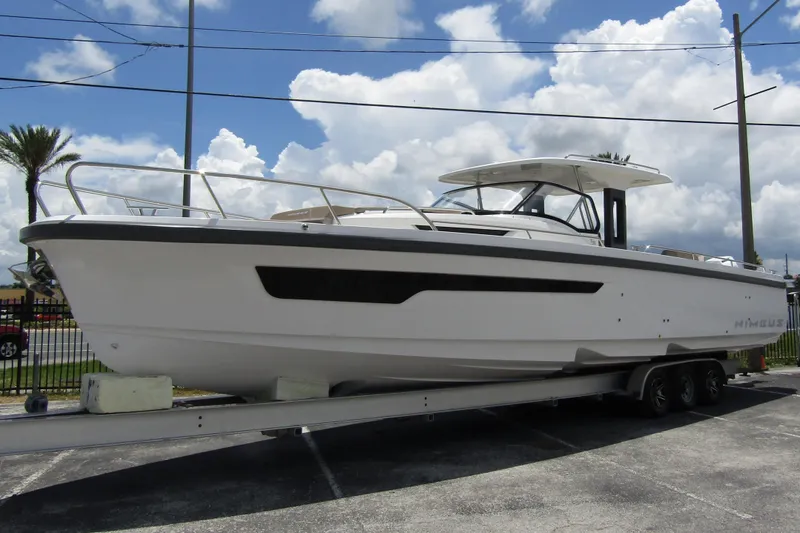Slide: The Image of 2025 Nimbus Tender 11 boat on trailer under cloudy sky. - 5