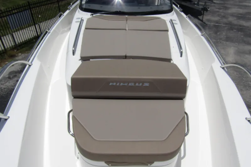 Slide: The Image of 2025 Nimbus Tender 11 boat with cushioned sunbathing area on deck. - 9