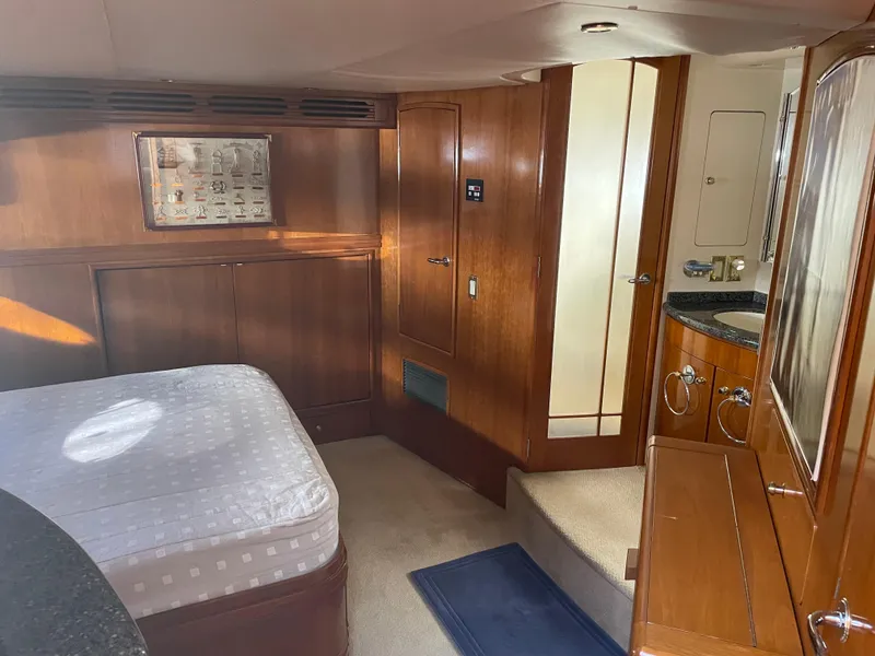 Slide: The Image of Interior of 2000 Carver 530 Voyager Pilothouse with wood paneling and bed. - 20