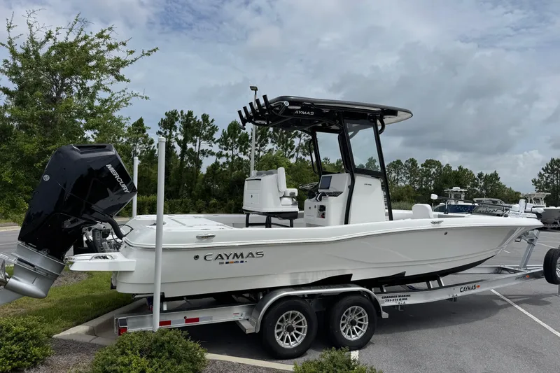 Slide: The Image of 2027 Caymas 26 HB boat on trailer, featuring sleek design and powerful Mercury engine. - 3