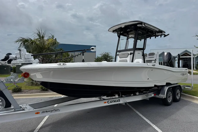 Slide: The Image of 2027 Caymas 26 HB boat on trailer, parked outdoors under cloudy sky. - 8