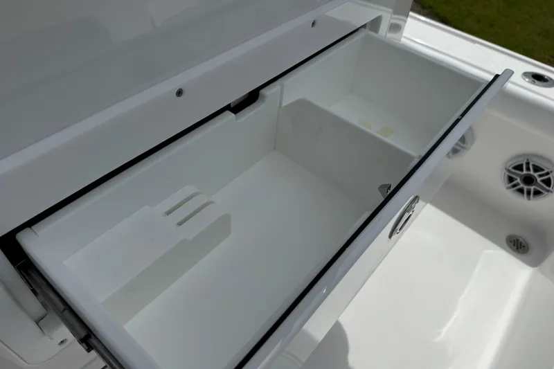 Slide: The Image of Open storage compartment on 2027 Caymas 26 HB boat, showcasing sleek design and functionality. - 16