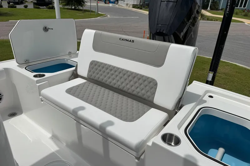 Slide: The Image of 2027 Caymas 26 HB boat interior with cushioned seating and storage compartments. - 14