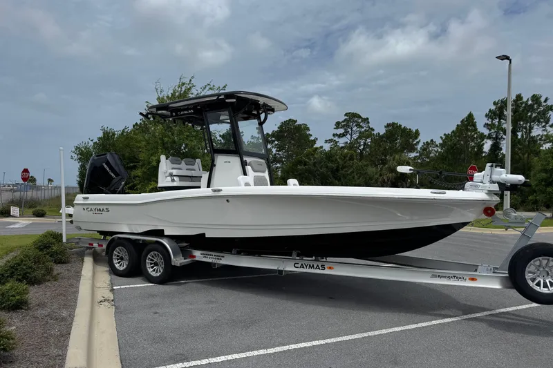 The Image of 2027 Caymas 26 HB boat on trailer in parking lot, cloudy sky background. - 1