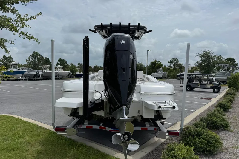 Slide: The Image of 2027 Caymas 26 HB boat on trailer, parked in a lot with other boats. - 5