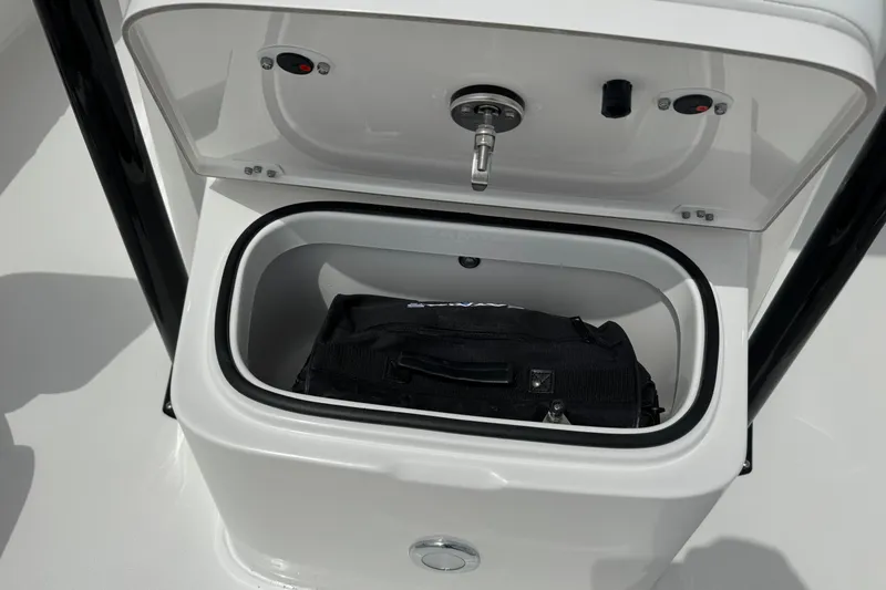 Slide: The Image of Storage compartment on 2027 Caymas 26 HB boat with a black bag inside. - 27