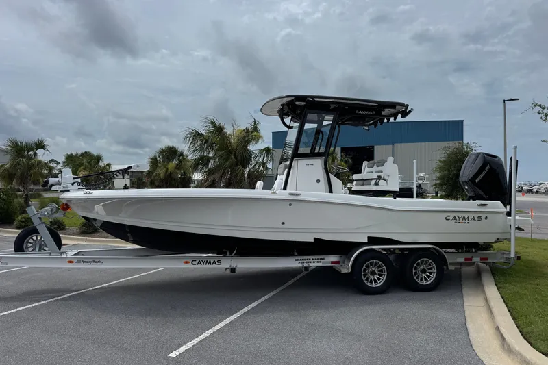 Slide: The Image of 2027 Caymas 26 HB boat on trailer, parked outdoors under cloudy sky. - 7
