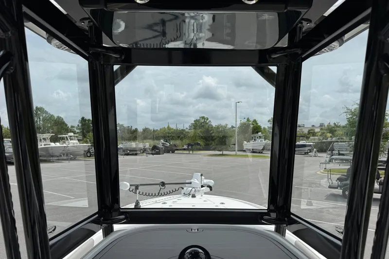 Slide: The Image of View from inside a 2027 Caymas 26 HB boat, showcasing the parking lot and surrounding trees. - 21