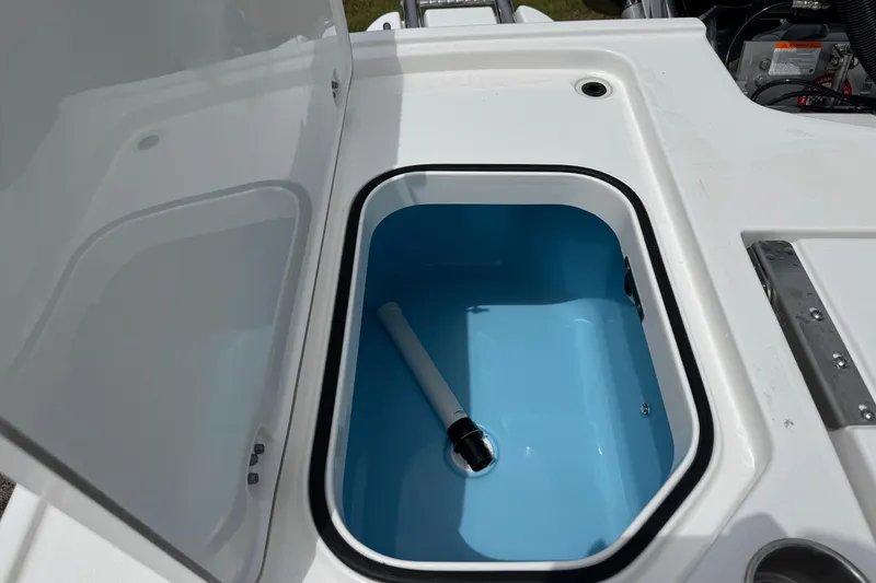 Slide: The Image of Open storage compartment on 2027 Caymas 26 HB boat, featuring a blue interior. - 12