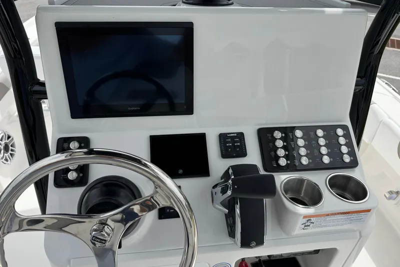 Slide: The Image of Control panel of 2027 Caymas 26 HB boat with steering wheel and electronic displays. - 19
