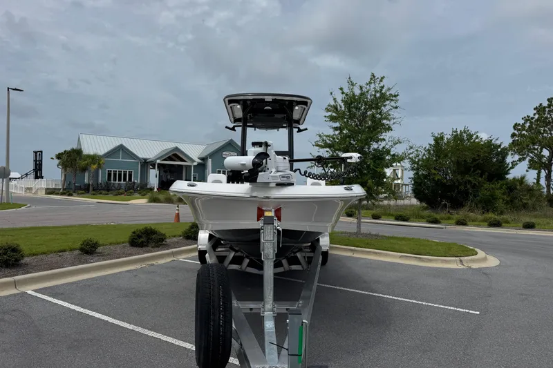 Slide: The Image of 2027 Caymas 26 HB boat on trailer in parking lot, cloudy sky background. - 9