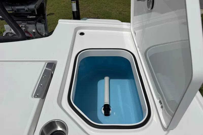 Slide: The Image of Open storage compartment on 2027 Caymas 26 HB boat, featuring a blue interior and white exterior. - 13