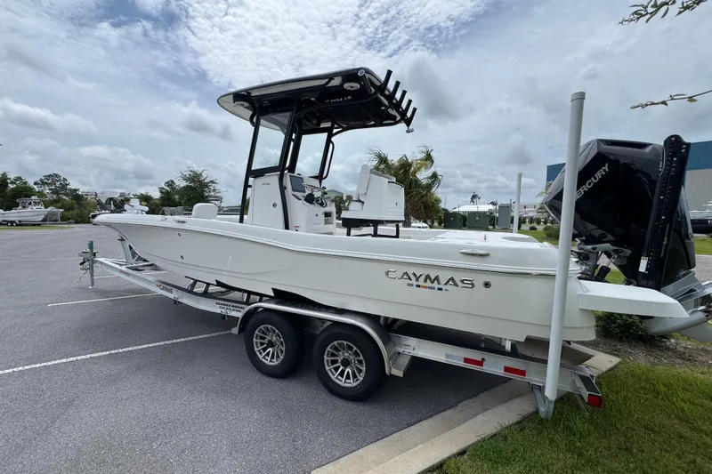 Slide: The Image of 2027 Caymas 26 HB boat on trailer, parked outdoors under cloudy sky. - 6