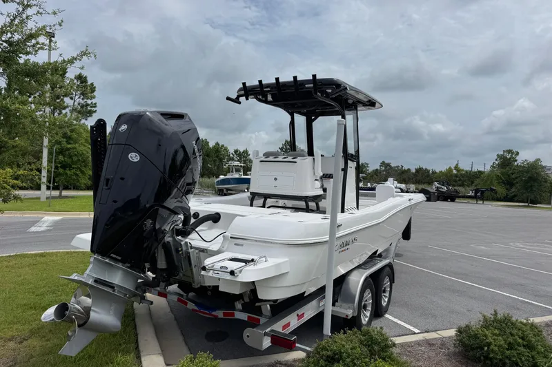Slide: The Image of 2027 Caymas 26 HB boat on trailer, parked outdoors under cloudy sky. - 4