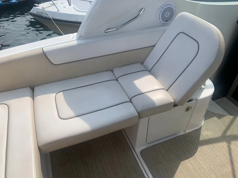 Slide: The Image of A sleek, cushioned seat on a boat, overlooking calm water. - 8