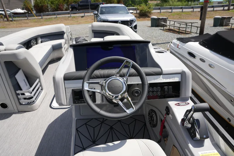 Slide: The Image of The image shows the helm of a 2027 Harris 250GM boat with a modern design. - 24