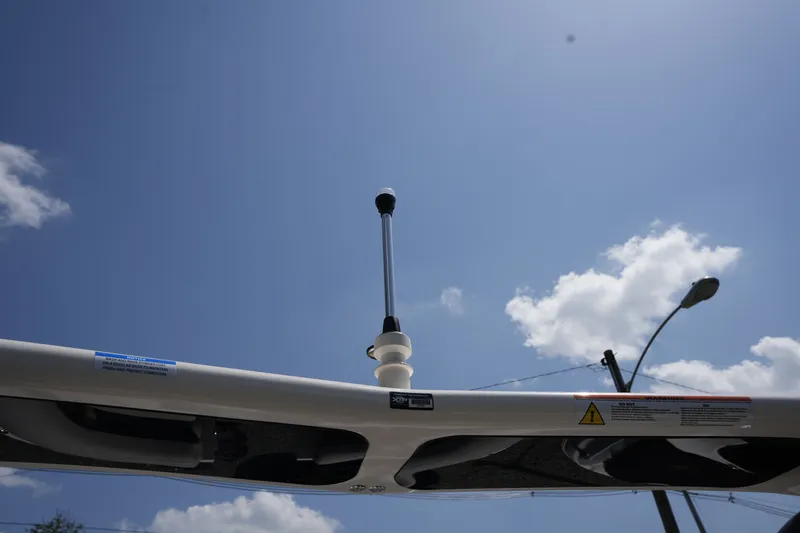 Slide: The Image of View of a Harris 250GM boat roof with antenna, against a blue sky and clouds. - 41