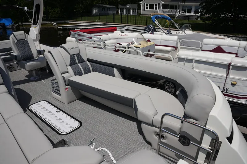 Slide: The Image of A luxurious pontoon boat with gray upholstery and sleek design, docked at a pier. - 14