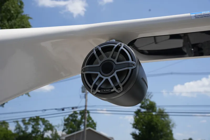 Slide: The Image of Close-up of a speaker on a boat, surrounded by trees and power lines. - 40