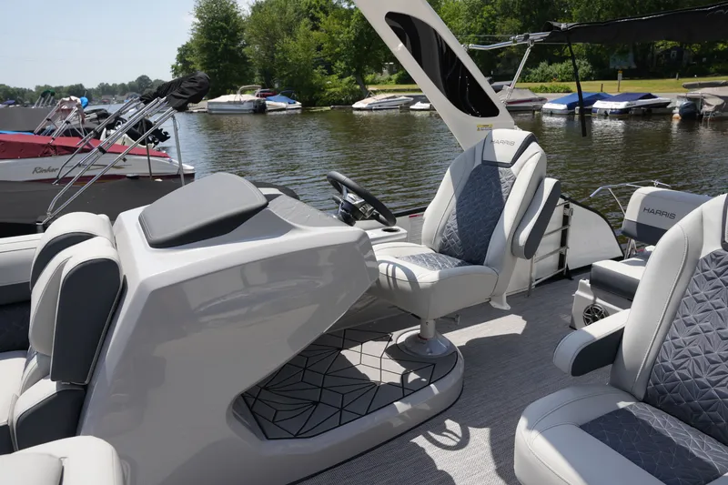 Slide: The Image of The image shows a modern pontoon boat with sleek seating and a helm station by the riverside. - 21