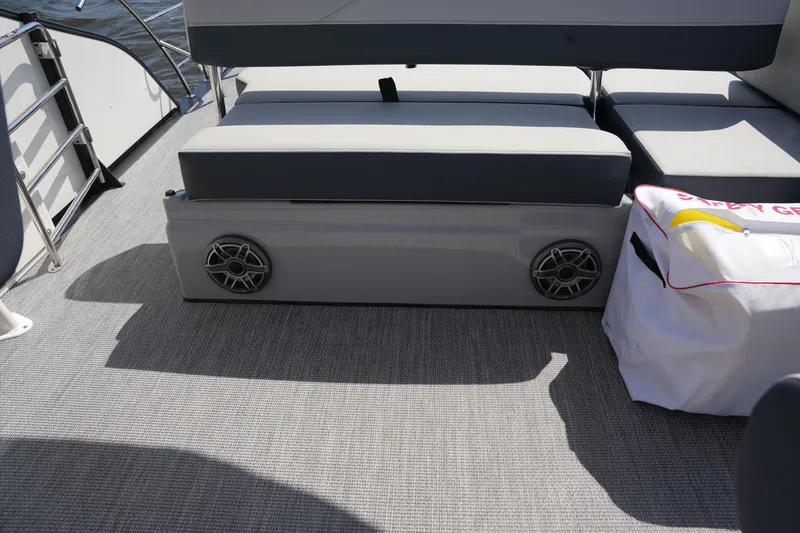 Slide: The Image of The image shows the deck of a Harris 250GM boat with gray seating and speakers. - 31