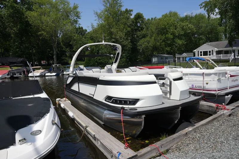 Slide: The Image of A modern pontoon boat by Harris, model 250GM, year 2027, docked at a pier. - 8